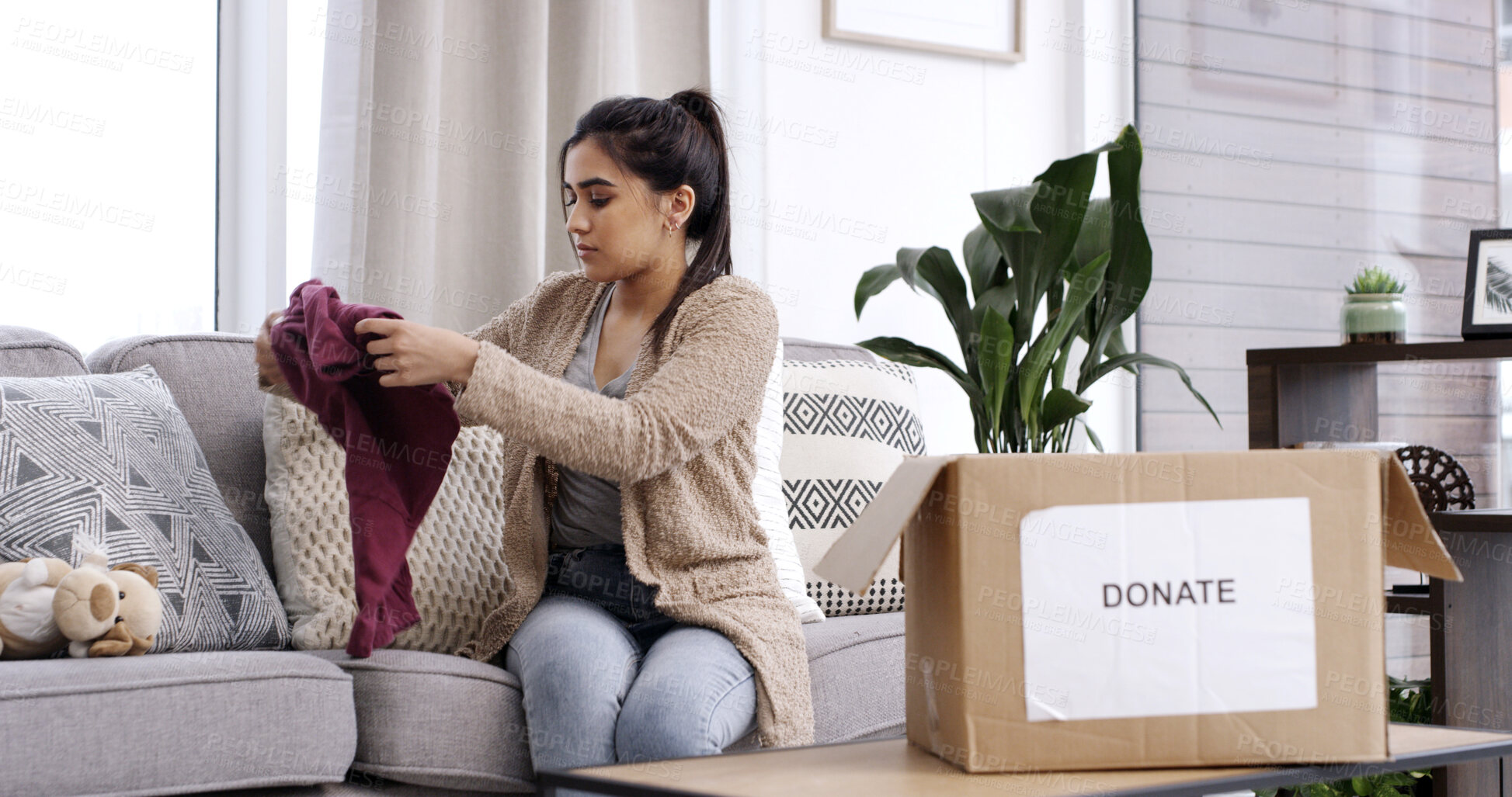 Buy stock photo Woman, folding clothes and donation box in house for charity initiative, nonprofit or declutter closet. Person, package and apparel giveaway in home for NGO contribution, support and spring cleaning.