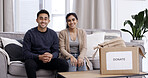 Portrait, couple and donation box in home with clothes for charity initiative, nonprofit and kindness. Married people, package and apparel giveaway with pride for NGO contribution, support and help.