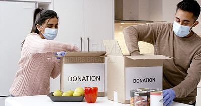 Buy stock photo Couple, donation and packing boxes for food drive, support or charity with face mask in home. People, volunteer and notes with help, gloves or social responsibility for poverty with accountability