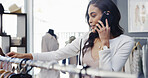 Happy woman, shopping and phone call with clothing line for fashion choice or decision in boutique. Female person, shopper and talking with mobile smartphone or smile for price check, style or outfit