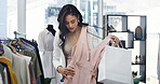 Woman, shopping and fashion with dress in store for decision, check quality and fabric texture. Female person, bag and choice for clothing, outfit option and retail selection for customer experience