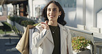 Happy woman, travel and thinking with shopping bags in city for purchase, fashion or style. Thoughtful, female person or shopper with smile or gifts for buying spree or payment on sidewalk in town