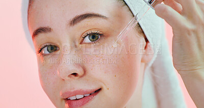 Buy stock photo Beauty, face and girl with serum in studio for hyaluronic acid, hydration and healthy skincare routine. Gen z, person and retinol oil application on pink background for vitamin c treatment and glow