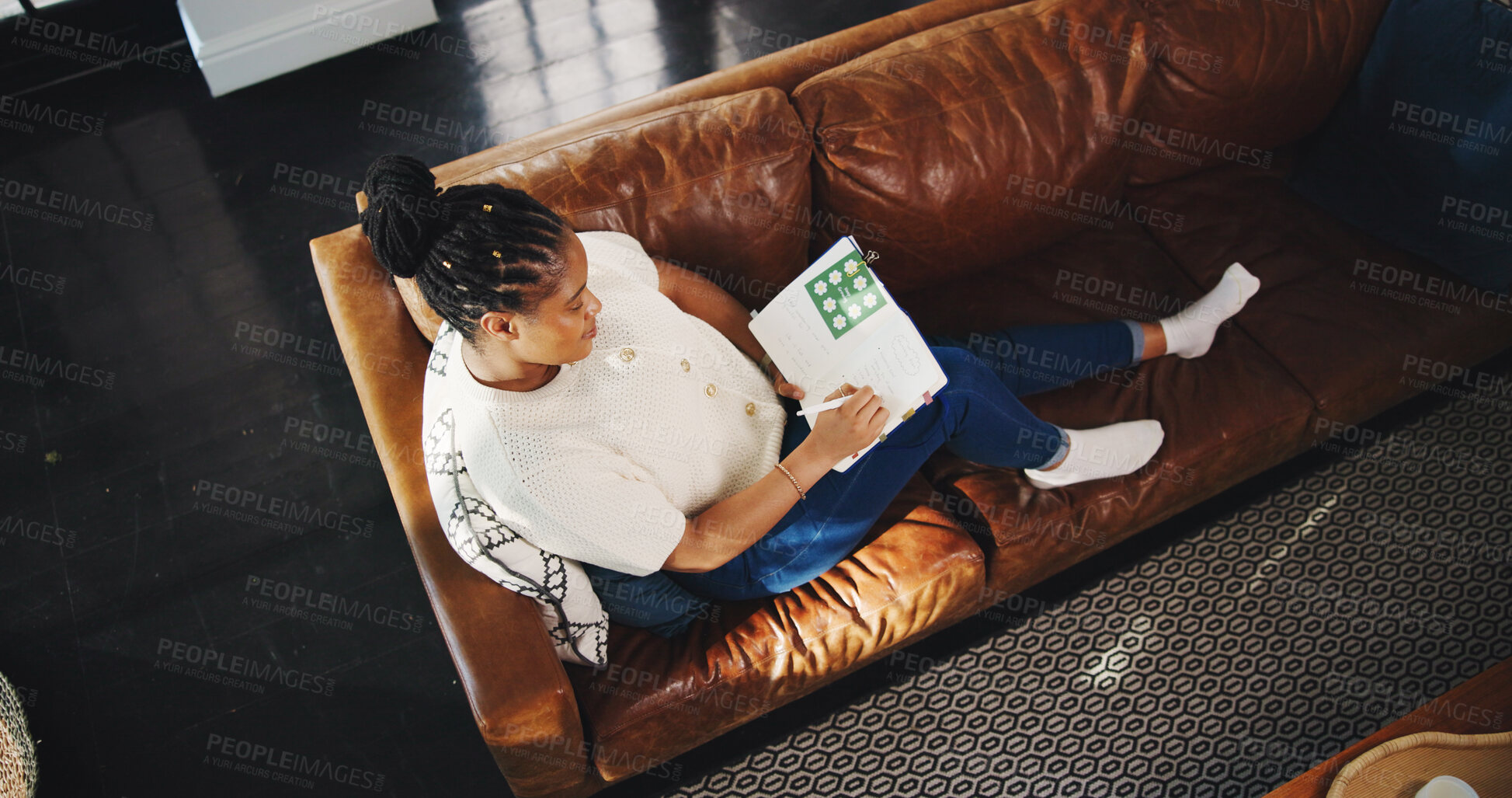 Buy stock photo Above, black woman and writing with notebook in living room for planning, schedule or checklist. Home, thinking and journal of freelancer for remote work, copywriting or ideas for article editor