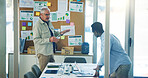 Businessmen, documents and meeting with pinboard for analytics or performance review in office. Men, employees or creative team with paperwork on board for project planning or statistics in workplace