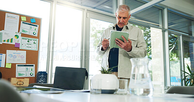 Buy stock photo Man, scroll or reading in office with tablet for sales performance stats, business management or planning. Mature person, research or browse in workplace with tech for SWOT analysis, charts or graphs