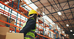 Logistics, boxes and person with trolley in warehouse to transport stock, cargo shipping or delivery. Supply chain, back of worker and low angle for package, storage management or inventory export