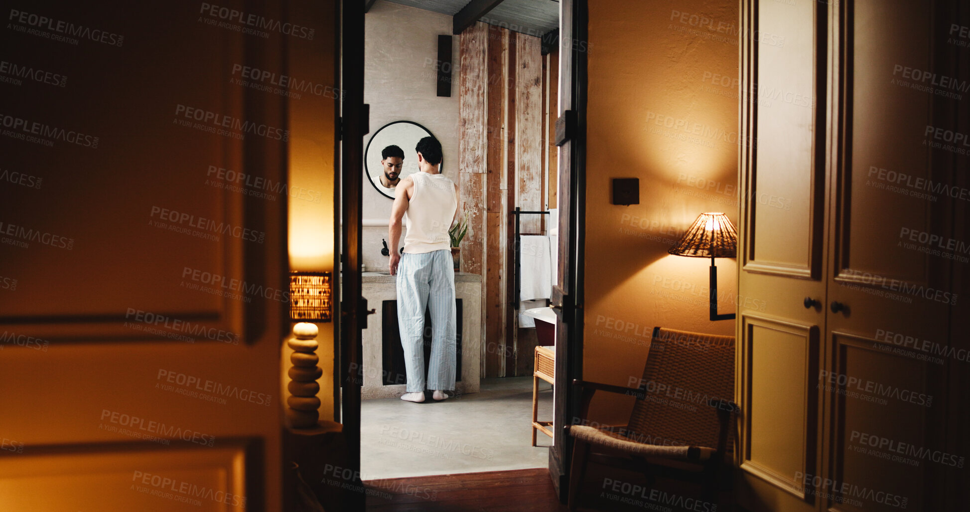 Buy stock photo Back, basin and doorway with man in bathroom of hotel room for hygiene or morning routine. Entrance, start and wake up with guest person at sink of lodge for accommodation, break or hospitality