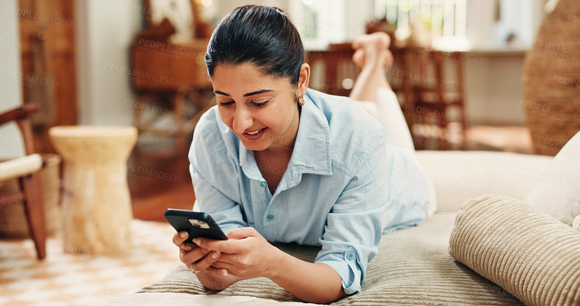Buy stock photo Happy woman, relax and scroll with phone on sofa for social media post, online dating or virtual chat. Person, chill or browse in home with tech for text message notification, internet or mobile app.