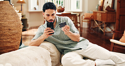 Buy stock photo Man, credit card and payment with phone on sofa for online shopping sale, purchase or internet banking. Fintech, person typing and eft transaction in home with tech, ecommerce mobile app or checkout.