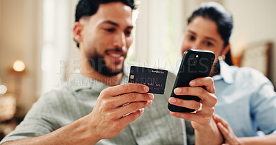 Buy stock photo Credit card, hands or couple on sofa with phone, online cart or gift payment in eft transaction. Happy, easy shopping or people at house with tech, present order or debit details for cashless service