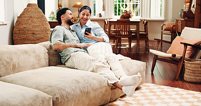Buy stock photo Couple, phone and relax on sofa, laugh and scroll for funny video, bonding or post in living room at house. Happy woman, man and smartphone with mobile app, chat and meme on social media at apartment