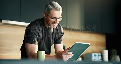 Buy stock photo Glasses, remote work and tablet with man in kitchen of home for planning, report or research. App, reading and small business with mature freelancer in apartment for schedule or startup review