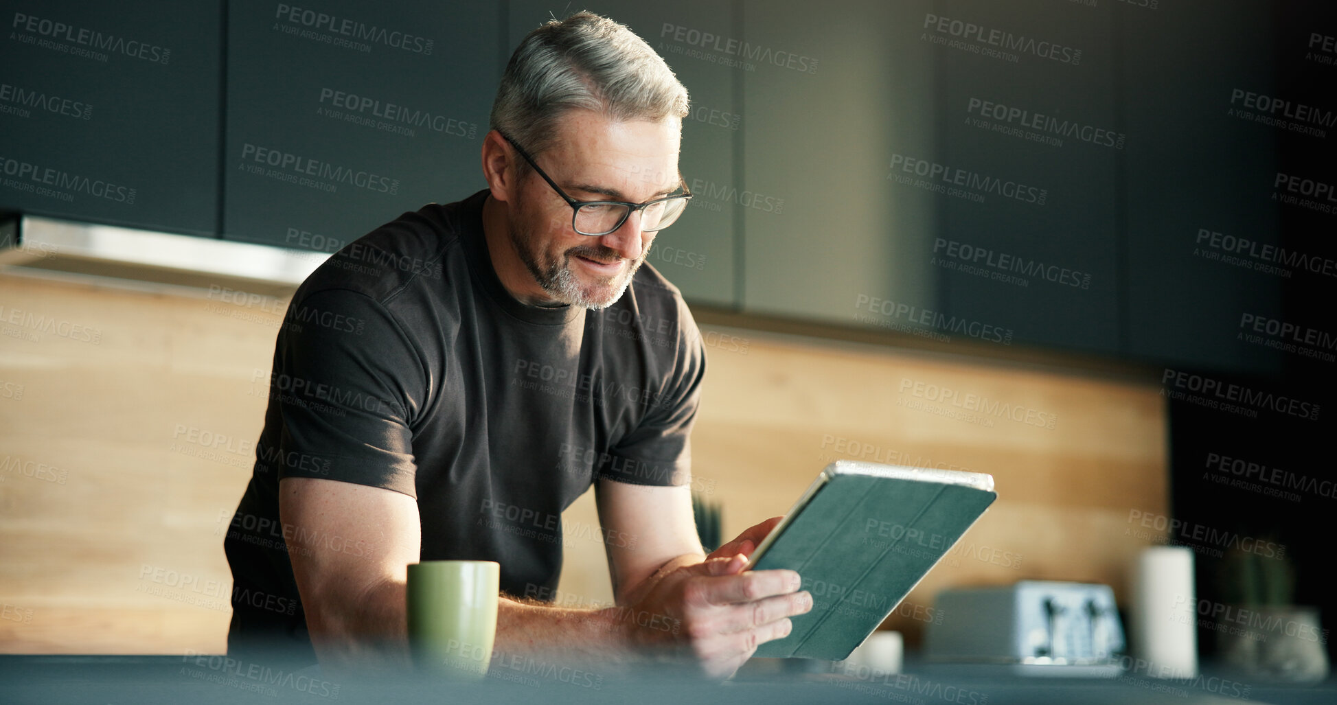 Buy stock photo Glasses, remote work and tablet with man in kitchen of home for planning, report or research. App, reading and small business with mature freelancer in apartment for schedule or startup review