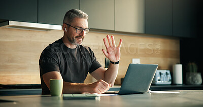 Buy stock photo Laptop, remote work and video call with man in kitchen of home for planning, report or research. Computer, earphones and wave with mature freelancer in apartment for virtual meeting or webinar