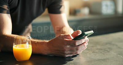 Buy stock photo Man, hands and orange juice in home with phone for social media, text message and online communication. Person, beverage and scroll with tech in house for news feed, virtual chat and internet search.