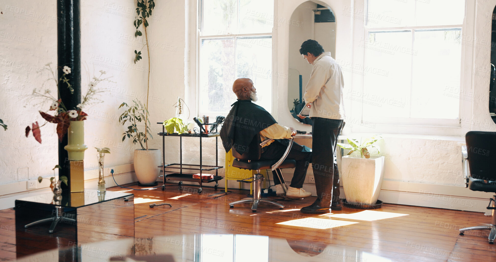 Buy stock photo Consultation, grooming and barber with client in salon for haircut, maintenance or discussion. Appointment, conversation and male hairdresser with customer for trim, hairstyle or self care in parlor.