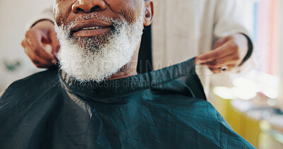 Buy stock photo Barber, hands and customer beard with cape for grooming service, start makeover and styling appointment. People, mature client and consultation in salon with facial hair trim, cover and preparation.