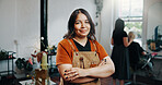 Woman, portrait and smile at hairdresser with arms crossed, confidence and pride for grooming service at store. Person, entrepreneur and happy at salon, job or apron for hairstyle at beauty parlor