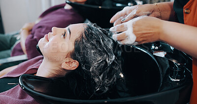 Buy stock photo Salon, woman and washing hair in basin with shampoo foam for maintenance, hygiene or cosmetic service. People, hairdresser and clean client scalp in sink with liquid soap, grooming and spa treatment.