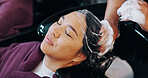 Relax, washing hair and hands with woman in salon for shampoo, conditioner or treatment for shine. Hygiene, grooming and hairdresser with female customer for head massage at basin in beauty parlor.