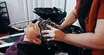 Hairdresser, customer or boy with washing at basin in salon, professional service or cleaning scalp. Child, shampoo treatment or people with stylist for hair care routine, head massage or high angle