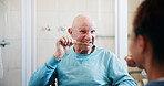 Senior man, nurse and help for brushing teeth in bathroom, motor skills exercise and dental hygiene in home. Caregiver, toothbrush and oral care for elderly person with disability in retirement