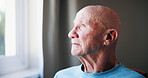 Thinking, window and senior man in house for memory, reflection or nostalgia with depression. Sad, planning and elderly male person with dementia in retirement with ideas, decision or choice in home.