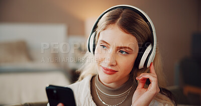 Buy stock photo Woman, headphones and phone with music in house, smile and listen with song on web in living room. Person, smartphone and happy for audio on mobile app, streaming subscription or relax at apartment