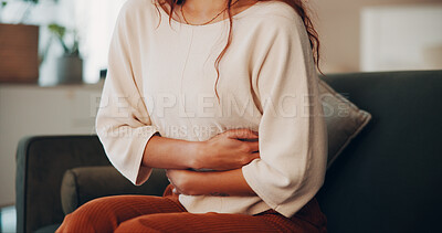 Buy stock photo Hands, woman and discomfort of stomach pain at house of menstruation, constipation and cramps. Female person, sore and uncomfortable from appendicitis, gastritis symptoms and chronic endometriosis