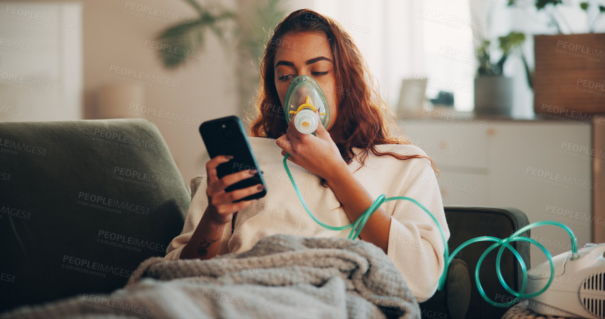 Buy stock photo Asthma, mobile or woman with nebulizer mask for medicine, respiratory disease or check social media. Chronic condition, recovery or person with phone for timer, lung health or reading chat in home