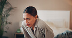 Woman, discomfort and stomach pain in bedroom at house of menstruation, constipation and cramps. Female person, sore and uncomfortable from appendicitis, gastritis symptoms and chronic endometriosis