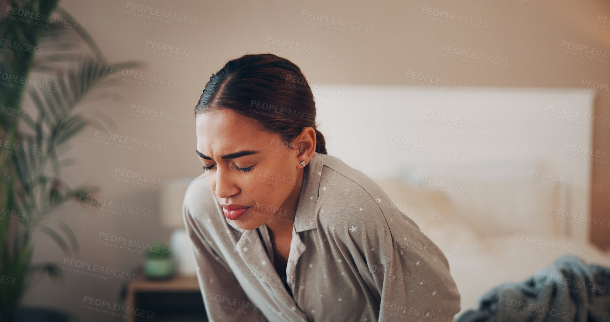 Buy stock photo Woman, discomfort and stomach pain in bedroom at house of menstruation, constipation and cramps. Female person, sore and uncomfortable from appendicitis, gastritis symptoms and chronic endometriosis