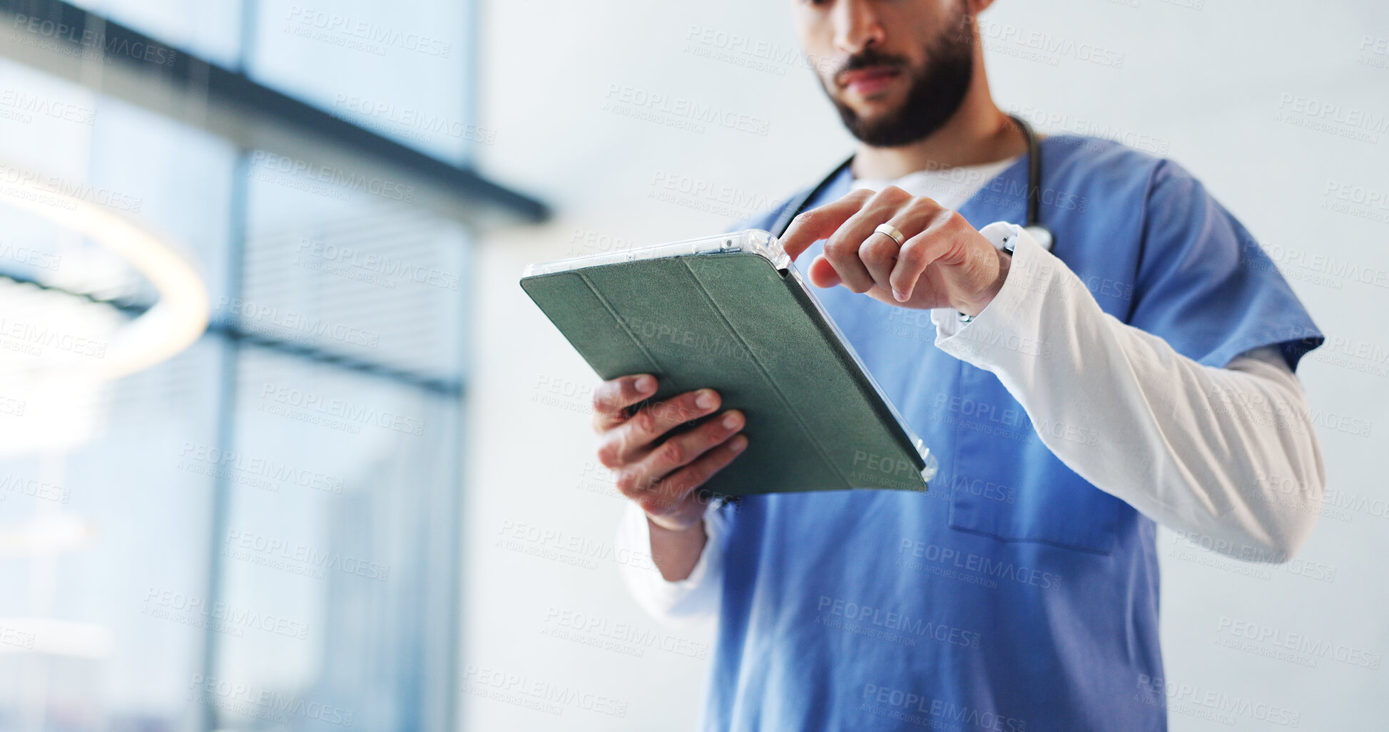 Buy stock photo Hospital, surgeon and below of man on tablet in lobby for patient results, medical report and research. Healthcare, doctor and person on digital tech for website, surgery schedule or help in clinic