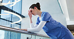 Nurse, woman and sad with stress in clinic for grieving loss, operation failure and medical trauma. Low angle, health professional and unhappy in hospital hallway for healthcare crisis or overwhelmed