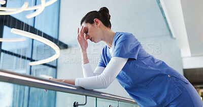Buy stock photo Nurse, woman and sad with stress in clinic for grieving loss, operation failure and medical trauma. Low angle, health professional and unhappy in hospital hallway for healthcare crisis or overwhelmed