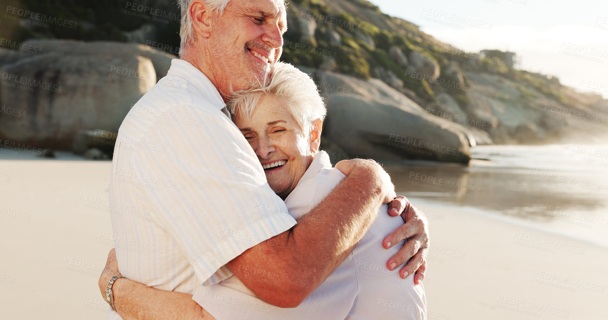 Buy stock photo Senior, happy couple and beach with hug for love, relationship or retirement holiday in nature. Elderly, man and woman with smile or embrace on ocean coast for summer weekend, outdoor getaway or date