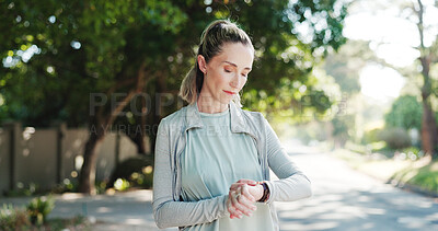 Buy stock photo Woman, fitness or checking watch with time for monitoring workout or tracking exercise in road. Active, female person or runner with wristwatch for training results, app or heart rate in neighborhood