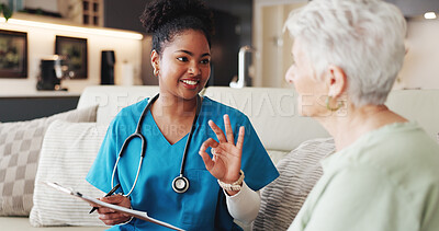 Buy stock photo Clipboard, explain or hand gesture with nurse and old woman on sofa in home living room for healthcare. Advice, checklist or smile with caregiver and senior patient in apartment for medical feedback