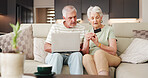 Credit card, ecommerce and laptop with old couple on sofa in living room of home together. Computer, online shopping and payment checkout with senior people in apartment for purchase or transaction