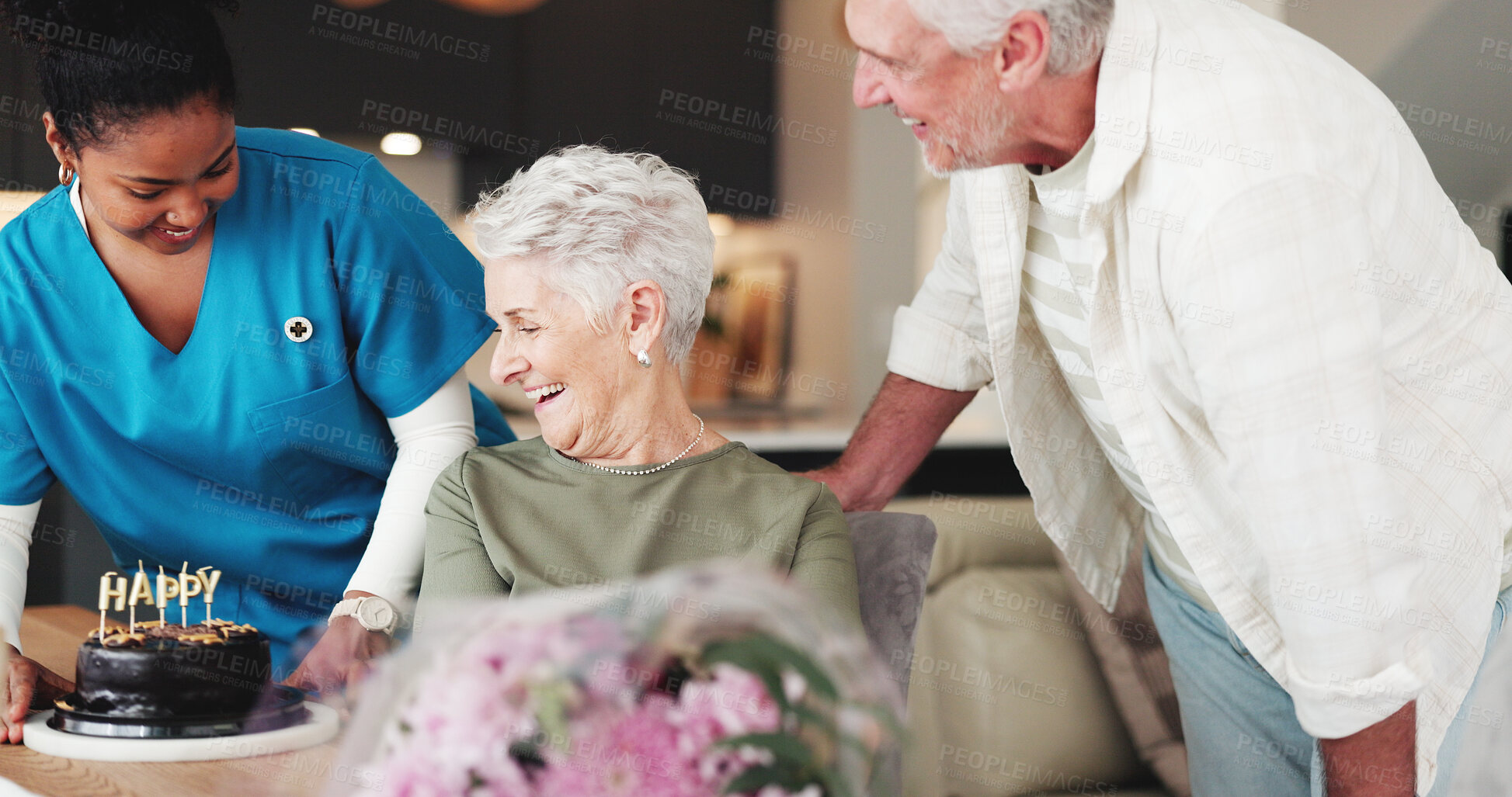 Buy stock photo Senior couple, caregiver and birthday with flowers for anniversary in retirement home together. Elderly, man and woman with nurse, cake or floral bouquet for love, romance or celebration in house