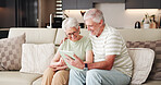 Tablet, happy and reading with old couple on sofa for streaming service, retirement or connection. Support, film search and subscription with senior man and woman with tech in living room of home