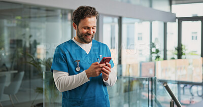 Buy stock photo Cellphone, man and nurse in hospital with typing for texting, communication or email for telehealth. Happy, technology and male healthcare worker with phone for contact, networking or medical support