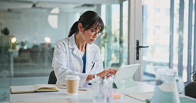 Buy stock photo Doctor, woman or typing on tablet in clinic for medical case review, treatment plan or telehealth app. Healthcare, expert and tech in office for surgery schedule, health update and hospital database