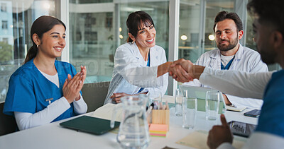 Buy stock photo Hospital, teamwork and doctors with handshake in meeting for promotion, agreement and partnership. Healthcare, medical staff and men and women shaking hands to celebrate, collaboration and thank you