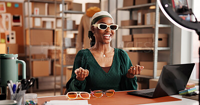 Buy stock photo Sunglasses, influencer and promotion with black woman in warehouse for startup, ecommerce and ring light. Content creation, online shopping broadcast and live streaming with person and accessory