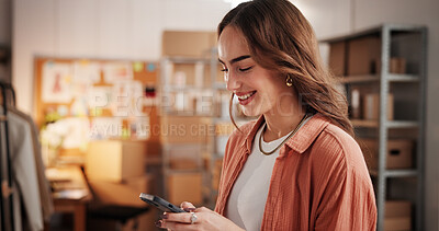 Buy stock photo Woman, designer and phone with texting at workshop, smile or dropshipping order at startup. Person, smartphone and mobile app for click, happy and fashion with creative project for clothes at studio