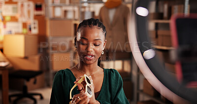Buy stock photo Sunglasses, ring light and ecommerce with black woman in warehouse for startup promotion and chat. Content creation, online shopping ambassador and influencer with person and accessory for broadcast 