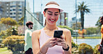 Woman, phone and texting with smile at tennis court, fitness or break for web chat at urban park. Person, athlete and smartphone on mobile app, social media or happy with training at sports club