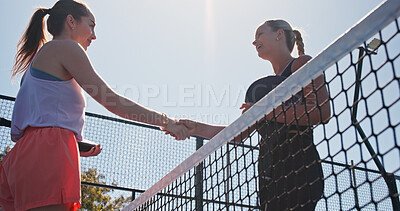 Buy stock photo Women, handshake and happy for match at tennis court, low angle and respect with padel game. People, net and shaking hands with racket, thanks or exercise in summer for motivation at sports club